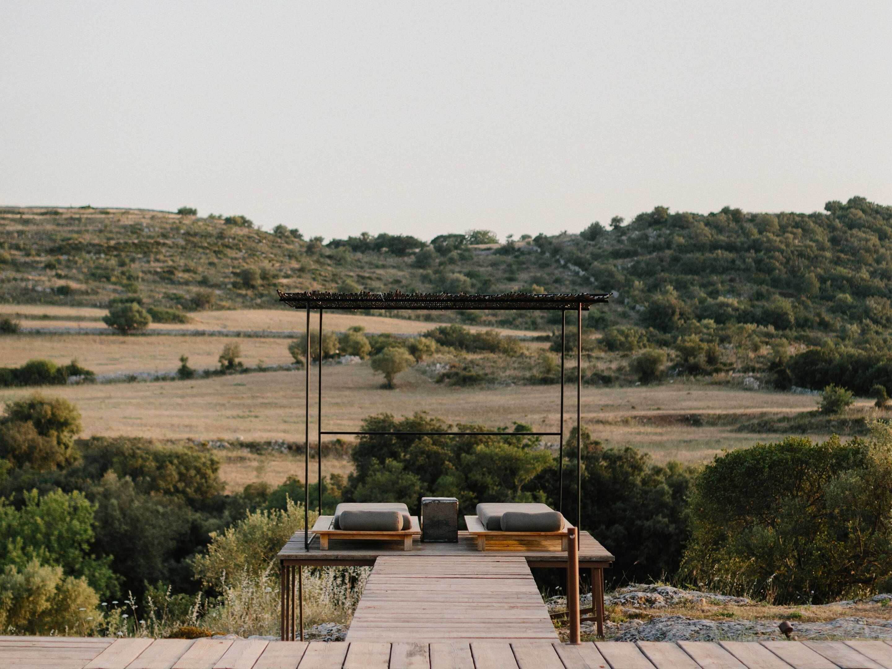 Two-lounge-chairs-with-the-rolling-green-hills-in-the-background